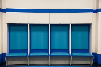 A multi-section modular bench with integrated overhead storage, featuring individual seating bays upholstered in light blue, and a white laminate structure with blue accents. — 3D model
