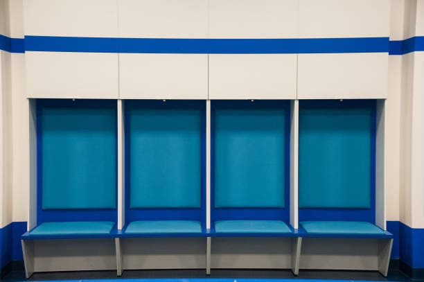 A multi-section modular bench with integrated overhead storage, featuring individual seating bays upholstered in light blue, and a white laminate structure with blue accents. — 3D model