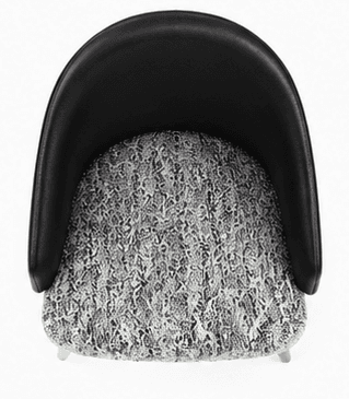 A contemporary upholstered armchair featuring a black, smoothly curved backrest and integrated armrests. The seat cushion is upholstered in a contrasting white and gray patterned fabric. The chair is supported by four dark, tapered wooden legs, lending it a sleek and modern appearance. — 3D model
