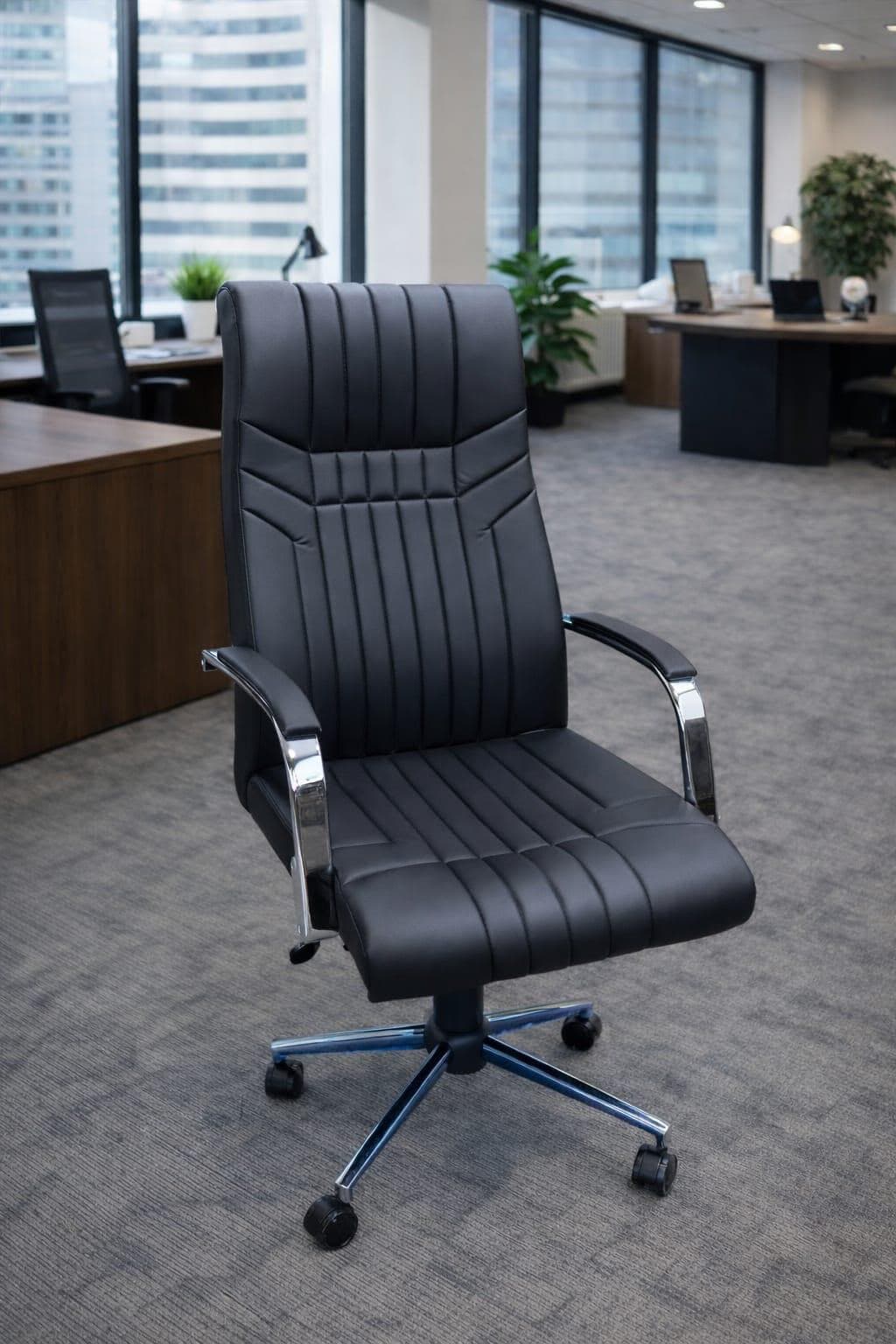 A black executive office chair with a high back, upholstered in faux leather, featuring vertical channel tufting, chrome-plated armrests with padded tops, and a five-star chrome base with casters. — 3D model