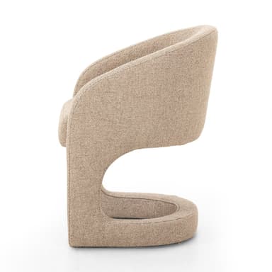A contemporary accent chair with a curved backrest and upholstered seat and frame. The chair features a rounded, open base structure that flows into the armrests and back. — 3D model