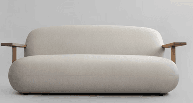 A contemporary two-seater sofa featuring a clean, rounded silhouette, upholstered in a light beige fabric. The design is characterized by its soft, cushioned appearance and distinctive integrated wooden armrests that extend from the backrest. — 3D model