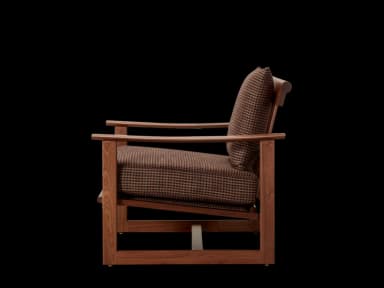 A wooden armchair with upholstered cushions. The frame is constructed from dark wood, likely walnut or a similar hardwood, featuring clean lines and a minimalist design. The seat and back cushions are upholstered in a patterned fabric, appearing to be a houndstooth or similar small-scale check in brown and black tones. The arms are curved and integrated into the wooden frame. — 3D model