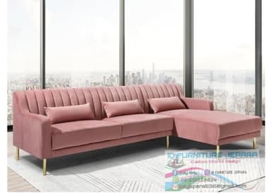 A modern right-hand facing sectional sofa upholstered in a blush pink velvet fabric. It features vertical channel tufting on the backrest, clean armrests, and rests on slender, tapered brass-finished metal legs. The sectional includes three matching rectangular lumbar support pillows. — 3D model