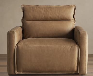 A contemporary recliner armchair upholstered in a tan or camel-colored leather, featuring thick cushioning, square-profile arms, and visible topstitching. — 3D model