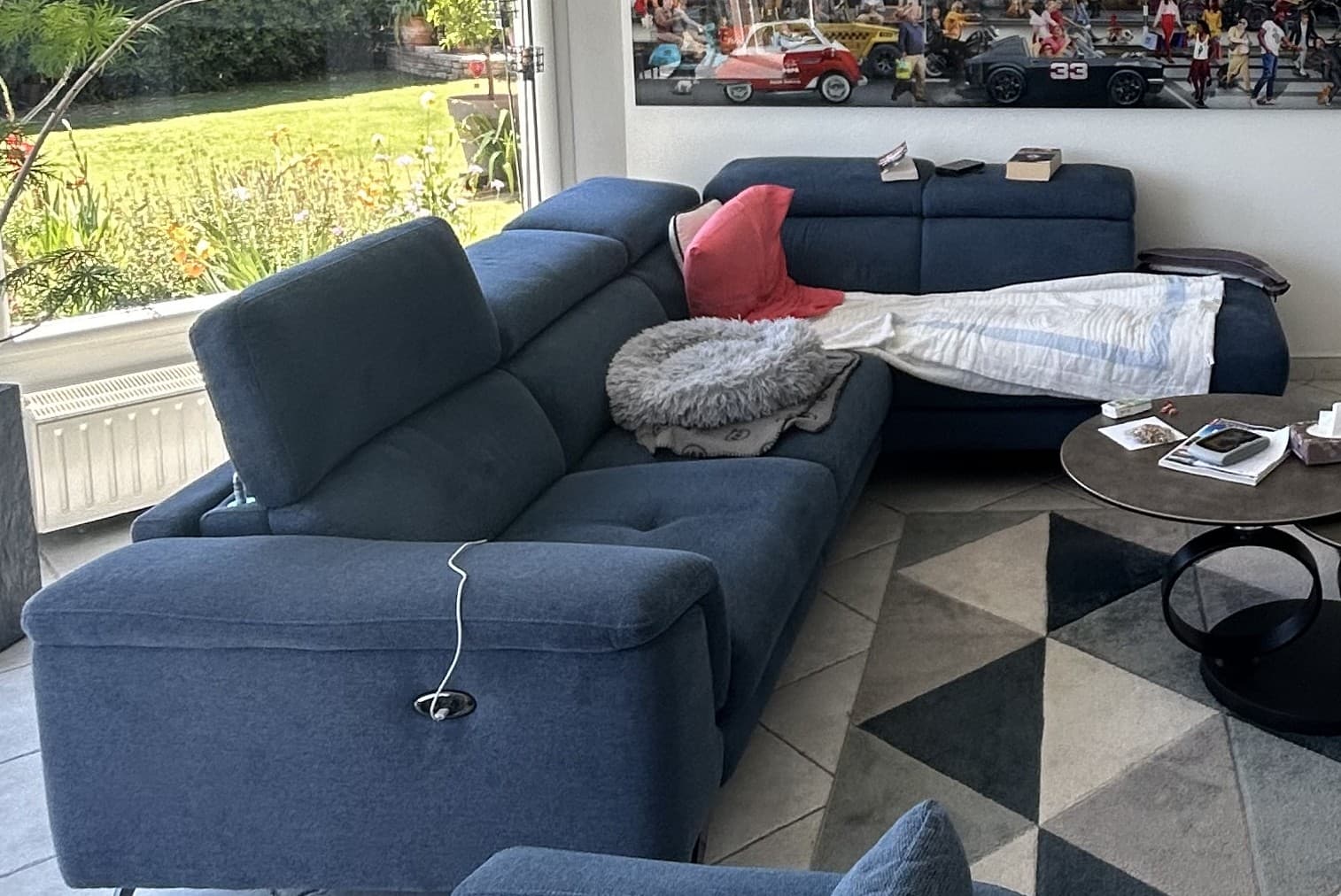 An L-shaped sectional sofa upholstered in a blue fabric, featuring modular sections, adjustable headrests, and integrated reclining mechanisms indicated by control buttons on the armrests. The sofa stands on minimalist metal feet. — 3D model