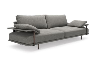 A contemporary two-seater sofa upholstered in a grey, textured fabric. It features a visible dark metal frame that extends to form the armrests and slender rectangular legs. The backrest is composed of loose cushions. One armrest is topped with an additional small cushion. The overall design is minimalist and modern. — 3D model