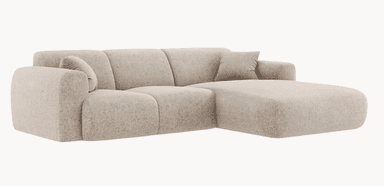 A modular sectional sofa with a chaise lounge extension. The sofa features plush, rounded armrests and a backrest divided into three distinct segments. It is upholstered in a textured fabric and includes two square throw pillows with ribbed detailing. The chaise is integrated seamlessly into the left side of the sofa as viewed from the front. — 3D model
