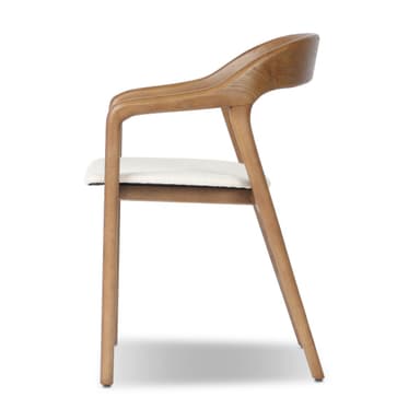 A contemporary dining armchair crafted from natural oak wood, featuring a sculpted, curved backrest and integrated armrests. The seat is upholstered in a textured ivory fabric, complementing the light wood tone. The chair stands on four straight, slightly tapered legs, providing a clean and modern aesthetic. — 3D model