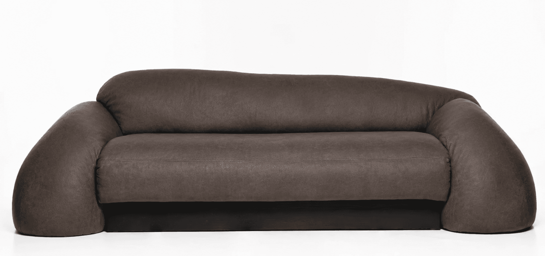 A contemporary sofa with rounded, plush arms and backrest. The upholstery appears to be a textured faux leather or similar material. The base is a solid, dark-colored plinth. The design features organic, curvilinear forms. — 3D model