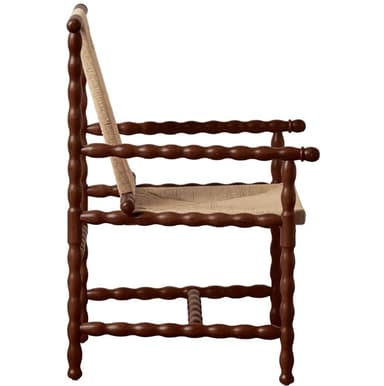 An armchair featuring a frame entirely constructed from bobbin-turned wood, finished in a dark brown hue. The seat and backrest are crafted from a tightly woven natural fiber, likely rush or a similar cord, in a light beige color. The backrest is angled for comfort, and the chair includes armrests with continued bobbin detailing. The legs and stretchers also feature the distinctive turned bobbin design. — 3D model