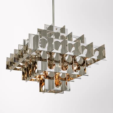 A modern chandelier featuring a modular, geometric design. The fixture is constructed from numerous rectangular and triangular metal elements arranged in overlapping layers, creating a complex, three-dimensional lattice structure. Circular cutouts are present within some of the rectangular panels, allowing light to pass through. The reflective surface gives it a metallic sheen. — 3D model