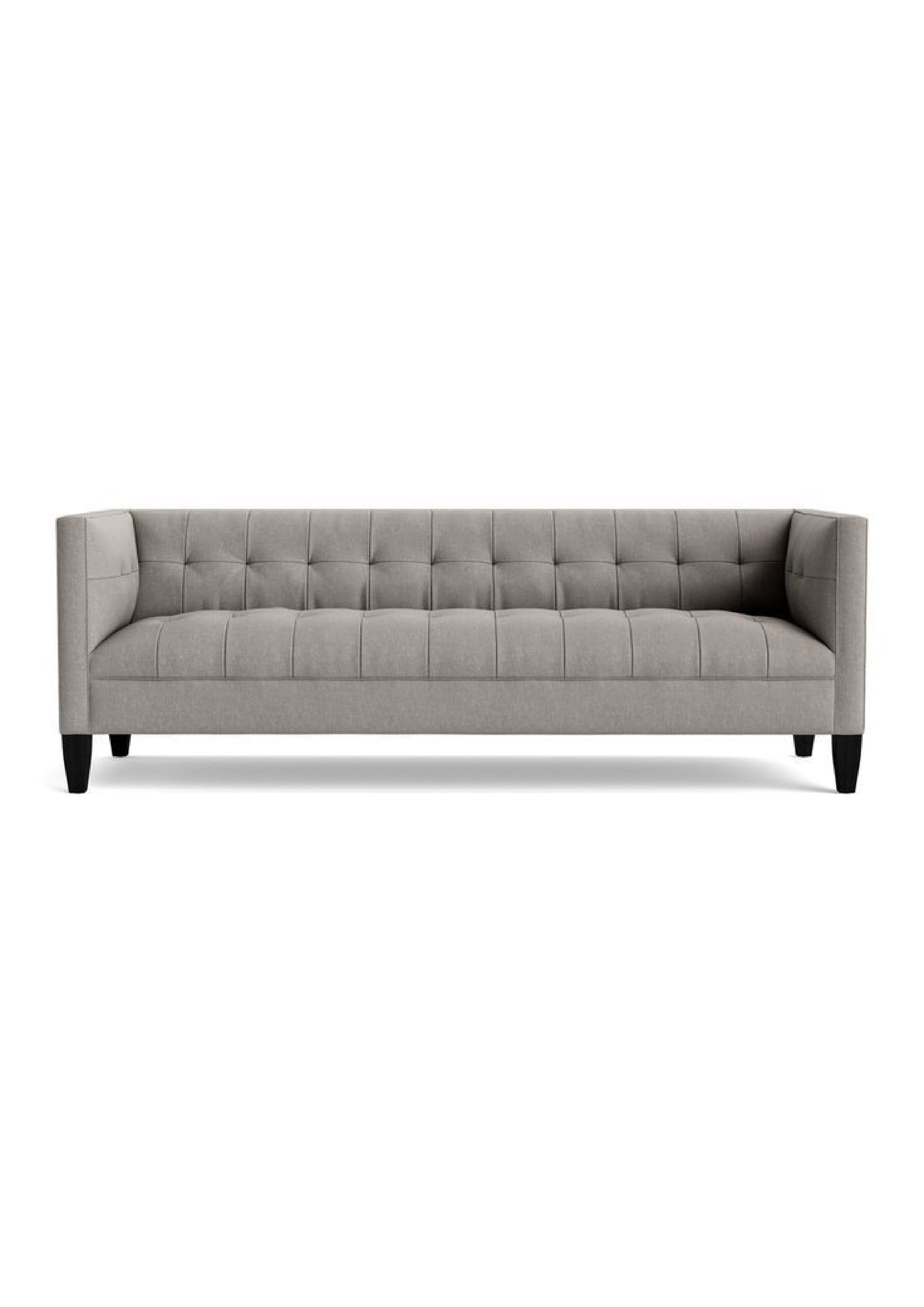 A contemporary three-seater sofa featuring a clean-lined silhouette, track arms, and a fully upholstered frame. The backrest and seat base are adorned with square channel tufting, creating a tailored and structured appearance. The sofa is supported by four dark, tapered block legs. — 3D model