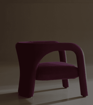 A compact, rounded lounge chair, upholstered in a deep magenta fabric, featuring a distinctive, sculptural silhouette with thick, continuous armrests and a low-slung seat. — 3D model