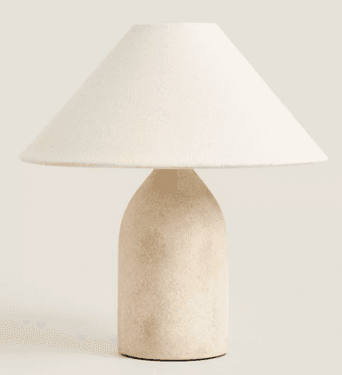 A contemporary table lamp featuring a rounded, textured beige ceramic base and a wide, conical off-white fabric shade, designed for ambient lighting. — 3D model