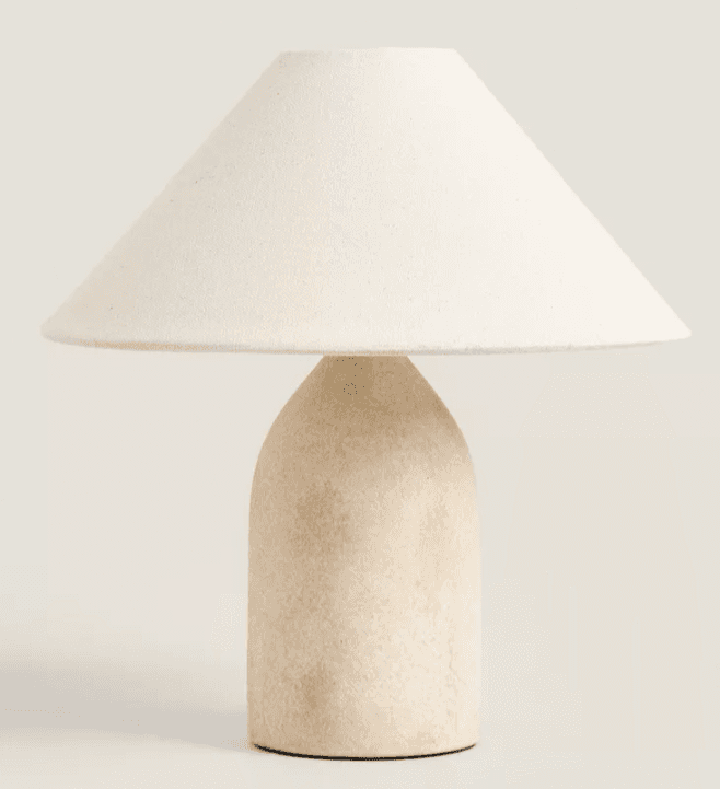 A contemporary table lamp featuring a rounded, textured beige ceramic base and a wide, conical off-white fabric shade, designed for ambient lighting. — 3D model
