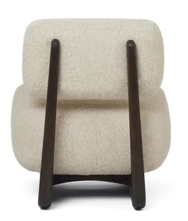 A modern, low-profile lounge chair featuring plush, off-white bouclé upholstery and a distinctive dark-stained wooden frame. The chair consists of a thick, cushioned seat and a separate, curved backrest, both generously upholstered. The solid wooden frame acts as both the base and the support for the backrest, showcasing smooth, rounded lines and a visible wood grain. — 3D model