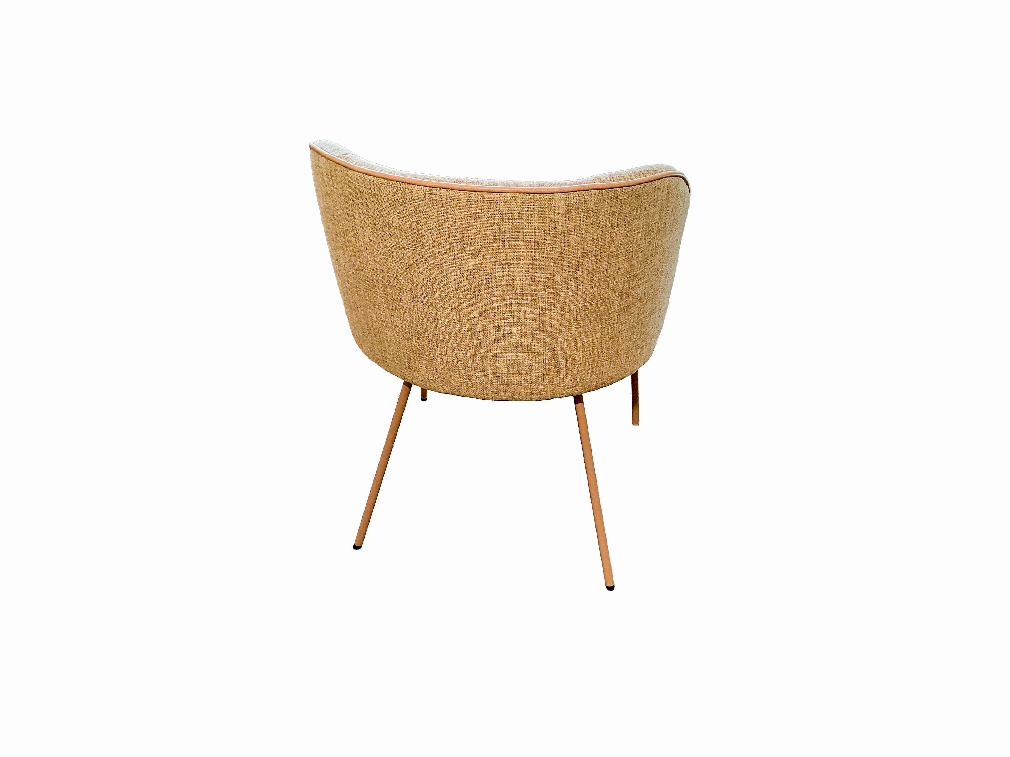 A view from the back of an upholstered armchair with a curved backrest. The chair has thin, tapered metal legs and is trimmed with a thin piping detail along the top edge of the backrest. — 3D model