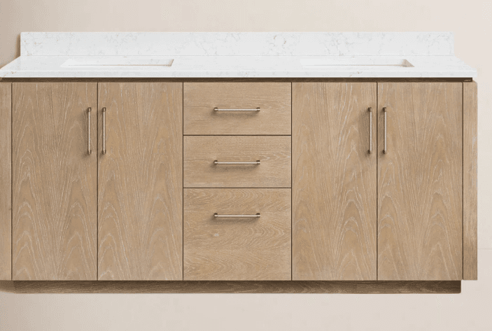A double vanity cabinet with a white countertop featuring two integrated sinks. The cabinet base is constructed from light-toned wood with a visible grain pattern, featuring four cabinet doors on the sides and three drawers in the center. Each door and drawer is fitted with brushed metal handles. The overall design appears modern and functional, suitable for a bathroom setting. — 3D model