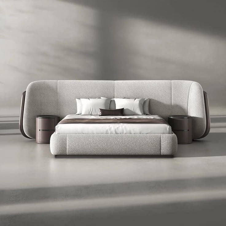 A modern, low-profile upholstered bed system featuring a wide, curved headboard with integrated circular nightstands. The bed frame and headboard are covered in a light grey textured fabric, while the nightstands and the outer, curved edges of the headboard feature a contrasting dark brown finish. The bed is presented with white and brown bedding. — 3D model