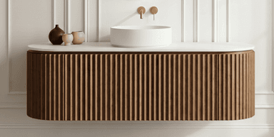 A contemporary wall-mounted bathroom vanity featuring a fluted wood cabinet, a white solid surface countertop, and a cylindrical white vessel sink, complemented by brass wall-mounted faucets. — 3D model