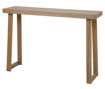 A minimalist console table crafted from light-toned wood, featuring a long, narrow rectangular top supported by two distinct leg structures. Each leg structure consists of two tapered vertical elements connected by a horizontal stretcher near the base, creating an A-frame-like silhouette. The overall design emphasizes clean lines and a natural aesthetic. — 3D model