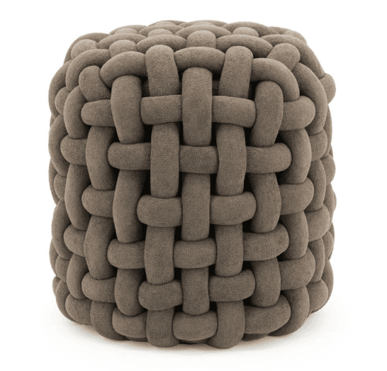 A cube-shaped ottoman constructed from thick, plush ropes woven in an interlaced pattern. The ropes are uniformly thick and appear to be made of a soft, textured fabric, giving the ottoman a rounded, cushioned appearance. The weaving creates a basket-like texture all around its visible surfaces. It has a substantial, solid form despite its soft materials. — 3D model