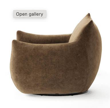 A plush, upholstered armchair with a distinctive rounded silhouette and gently curved arms that taper to a point. The backrest is high and also curves inwards. The overall design suggests a modern, organic aesthetic. — 3D model
