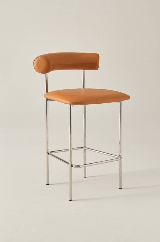 A modern bar stool featuring a polished chrome-plated tubular steel frame, upholstered in tan leather. It has a square seat and a distinctive cylindrical, padded backrest, with a rectangular footrest bar connecting the front legs. — 3D model