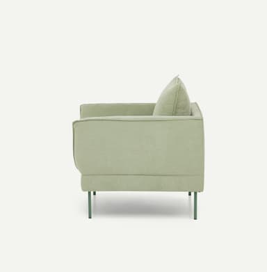 A contemporary upholstered armchair featuring a soft, muted sage green fabric, loose seat and back cushions, and slender, complementary dark green metal legs. — 3D model