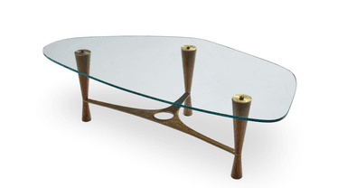 A glass-top coffee table with a distinctive mid-century modern design, featuring a sculptural brass frame and tapered wooden legs. — 3D model