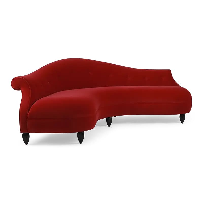 A red velvet chaise lounge with a curved, asymmetrical design. It features a high, rounded back that tapers down on one side, and a low, elongated seat. The upholstery appears tufted with visible buttons along the backrest. It is supported by four short, dark-colored legs with a decorative, bulbous base. — 3D model