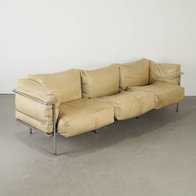A sectional sofa with a light beige leather upholstery and a chrome frame. The sofa consists of multiple cushion modules, with the back cushions appearing somewhat unstructured and draped. The frame is visible on the sides and forms the legs of the sofa. The overall design suggests a modern or contemporary aesthetic. — 3D model