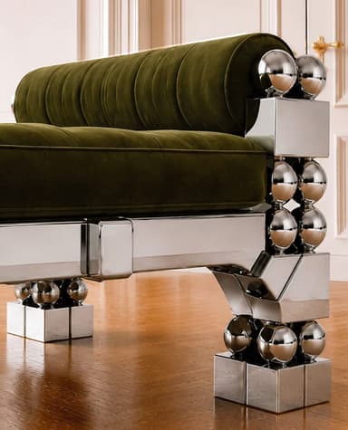 A striking postmodern daybed featuring a polished chrome frame with intricate geometric and spherical details, paired with a tufted, rich brown upholstered cushion and cylindrical bolster pillows at each end. The metallic frame consists of rectangular and triangular elements adorned with stacked chrome spheres, creating a bold and reflective aesthetic. — 3D model