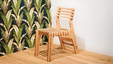 A modern wooden chair with a slatted seat, back, and legs. The design is characterized by its layered construction, giving it a modular appearance. The backrest features horizontal slats, while the seat is composed of parallel curved slats. The legs are straight and perpendicular to the seat. — 3D model