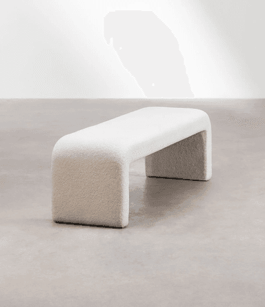 A cream-colored, bouclé upholstered bench with a rounded, continuous form. The bench has a singular, sculptural design where the seat and legs are integrated into a unified U-shape, creating a modern and minimalist aesthetic. — 3D model