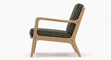An armchair featuring a light wood frame with exposed armrests and legs, and a backrest upholstered in a black and tan geometric patterned fabric. The image shows the chair from the rear. — 3D model