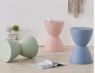 A light blue, hourglass-shaped accent stool made from molded plastic, featuring a smooth, matte finish and a minimalist design. It can function as seating or a small side table. — 3D model