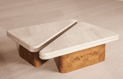 A modular coffee table set consisting of two triangular units. Each unit features a thick, rounded tabletop made of light beige travertine, resting on a geometric base constructed from golden-brown burl wood. — 3D model