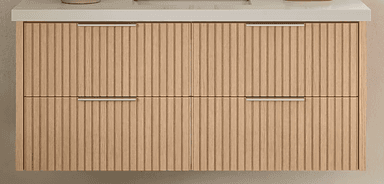 A modern bathroom vanity featuring a light wood-toned base with a distinctive fluted or reeded texture on its two drawer fronts. It is topped with a smooth, light-colored solid surface countertop and includes two minimalist silver-tone bar handles. — 3D model