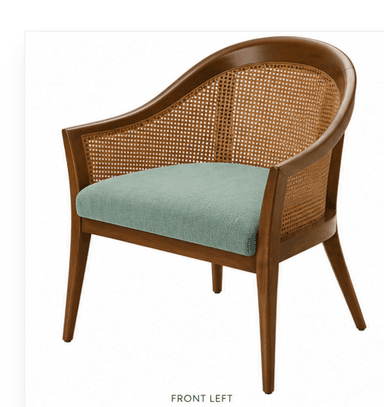 A medium-brown wooden armchair featuring a curved backrest and integrated armrests. The backrest is crafted from woven cane, providing a light, breathable texture. The chair is supported by four tapered, splayed legs. The overall design suggests a Mid-Century Modern aesthetic. — 3D model