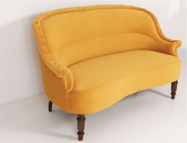 A traditional style armchair upholstered in a rich yellow velvet fabric. The chair features distinct rolled arms and a rolled crest rail on the backrest. It has four wooden legs, with a visibly turned leg at the front and a tapered leg at the rear. — 3D model