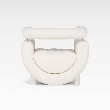 A contemporary cream-colored accent chair featuring a distinctive U-shaped upholstered body with a separate, cylindrical backrest/armrest element supported by thin brass rods. The chair is upholstered in a soft boucle fabric and stands on short, cylindrical upholstered legs. — 3D model