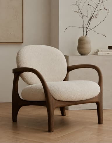 A contemporary lounge chair featuring a sculptural dark wood frame and plush, rounded bouclé upholstery. The chair has a minimalist yet organic design, with seamlessly integrated armrests that flow into the legs. The backrest and seat cushions are generously padded, providing a comfortable seating experience. — 3D model