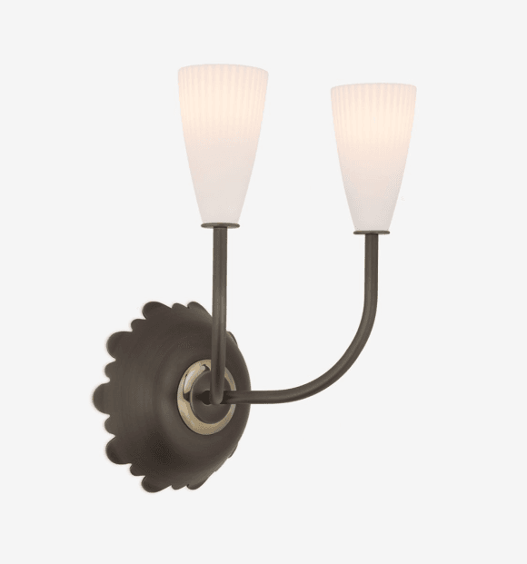 A double-armed wall sconce with two frosted glass shades. The shades are tapered and feature vertical ribbing. The arms are curved and support the shades at the ends. The base plate is circular with a decorative scalloped edge and a central brass accent. — 3D model