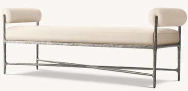 An industrial-style upholstered bench featuring a cream-colored fabric cushion and cylindrical bolsters on each end, supported by a dark, textured metal frame with an X-stretcher detail. — 3D model