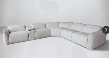 A large, L-shaped reclining sectional sofa upholstered in light beige, textured fabric. It features multiple modular components, including two end recliners with adjustable headrests and an integrated console with two cup holders between two seats. The design is contemporary with clean lines. — 3D model