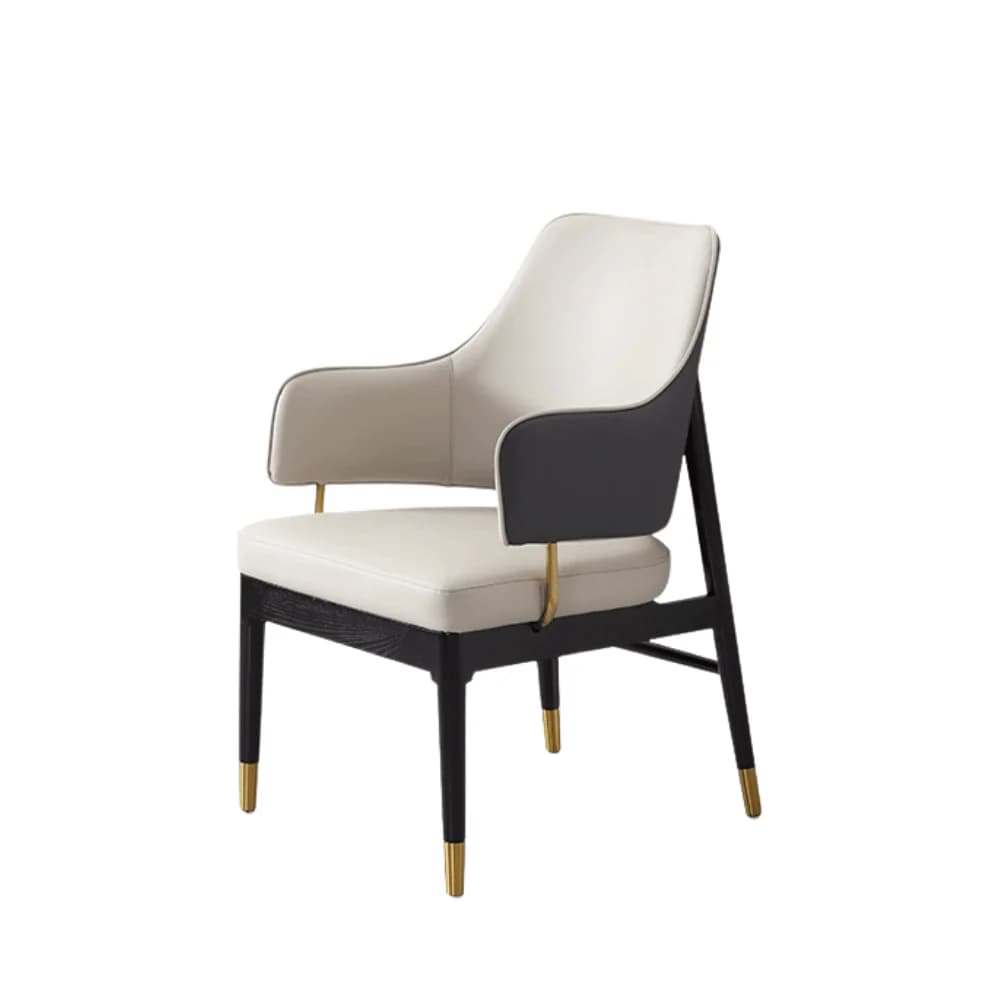 A modern armchair with a combination of materials and colors. The seat and backrest are upholstered in a light-colored material, possibly leather or a high-quality fabric, with contrasting dark grey panels on the sides of the backrest. The frame appears to be constructed from dark wood, with slender black legs that are accented with gold-colored caps at the feet. The armrests are integrated into the structure and are also upholstered. — 3D model