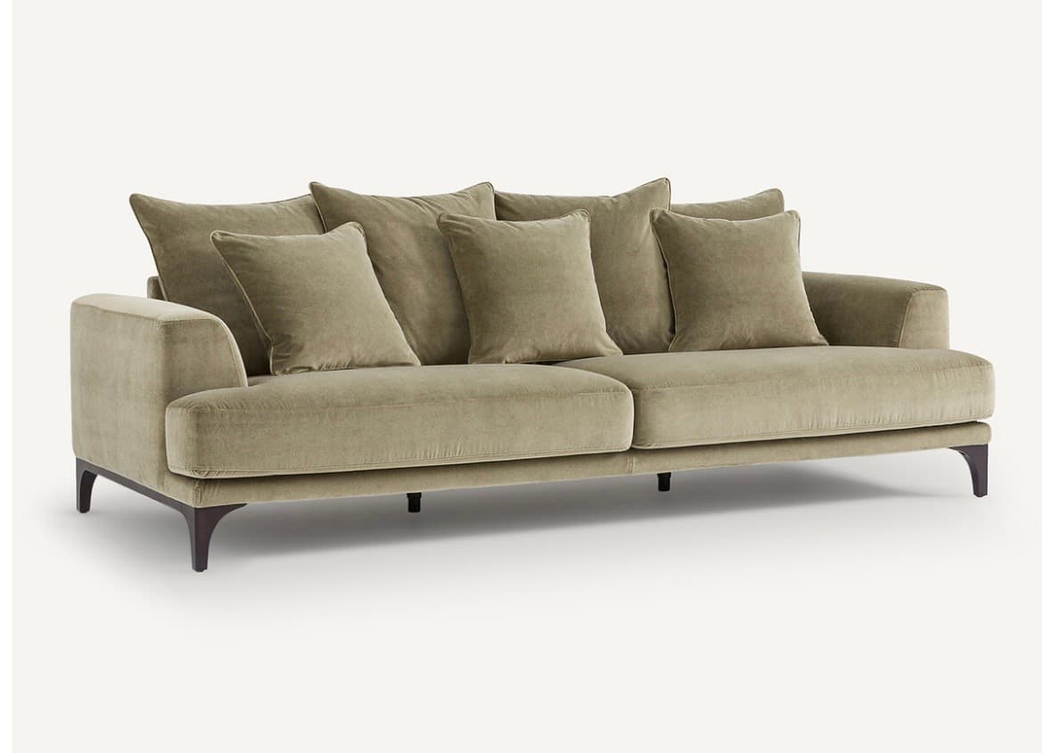 A contemporary sofa with a plush, upholstered finish. It features a three-seat configuration with deep cushions and multiple throw pillows for added comfort. The sofa is supported by dark, tapered legs, suggesting a modern or mid-century modern aesthetic. The upholstery appears to have a soft texture, possibly velvet or a similar fabric. — 3D model