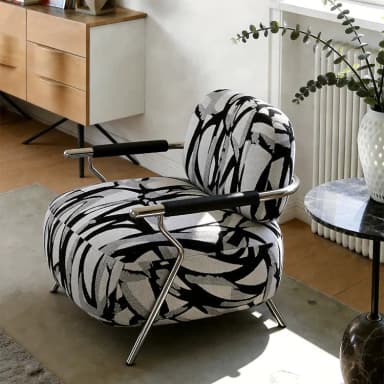 A modern armchair featuring a barrel-style upholstered seat and back, supported by an exposed tubular metal frame that also forms the armrests. The upholstery has a distinctive abstract black, grey, and white pattern. Dimensions are indicated as 71cm (height), 84cm (width), and 81cm (depth). — 3D model